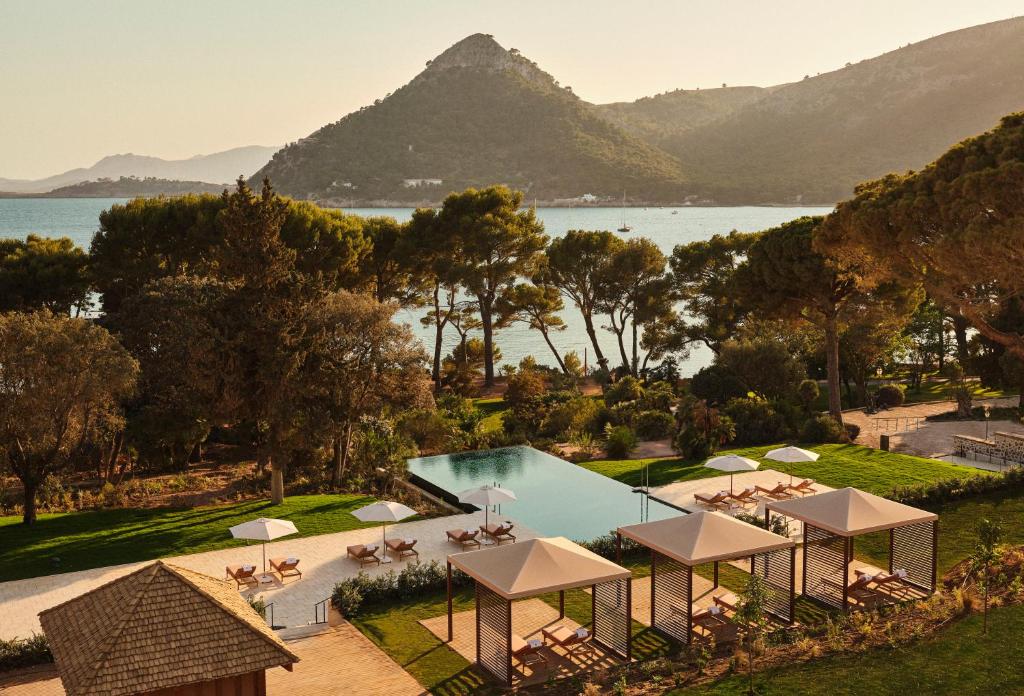 Four Seasons Resort Mallorca overlooking the Mediterranean Sea, featuring elegant architecture, lush greenery, and serene coastal views.